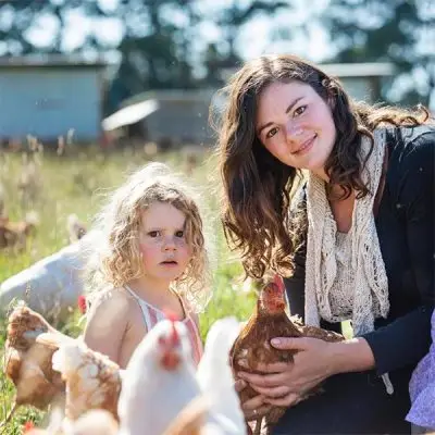 Madelaines-Eggs - CERES Fair Food - CERES Fair Food Madelaine with chooks and daughter in their organic farm pasture, at Madelaines Eggs