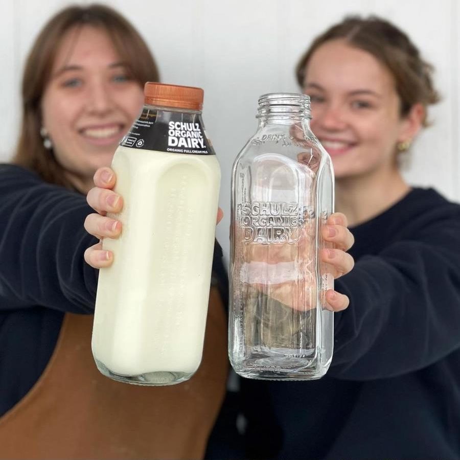 Staff at Schulz Dairy, with milk in glass