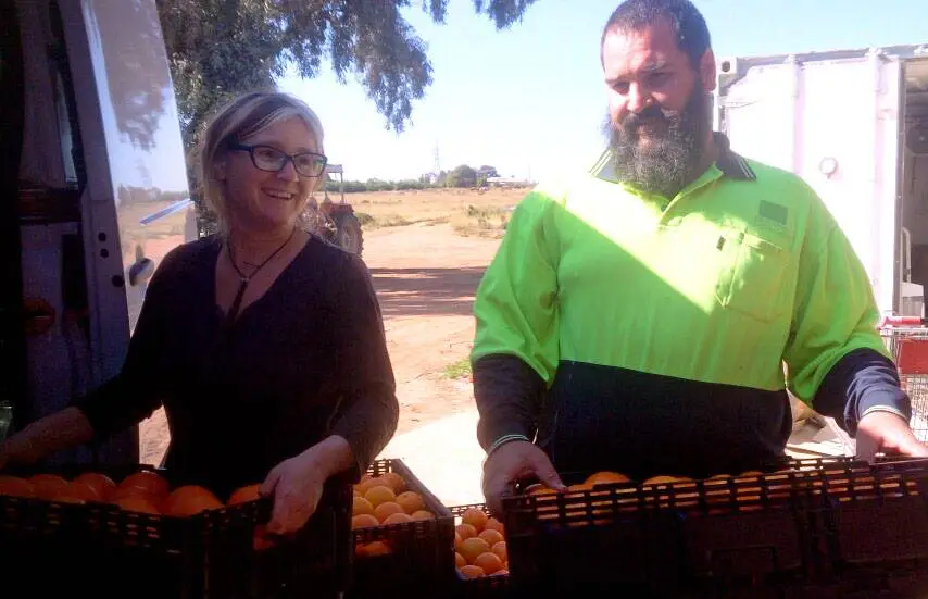 Phoebe-and-Francis-Orange-Lady - CERES Fair Food Phoebe and Francis with citrus harvest, on family farm. The Orange Lady.