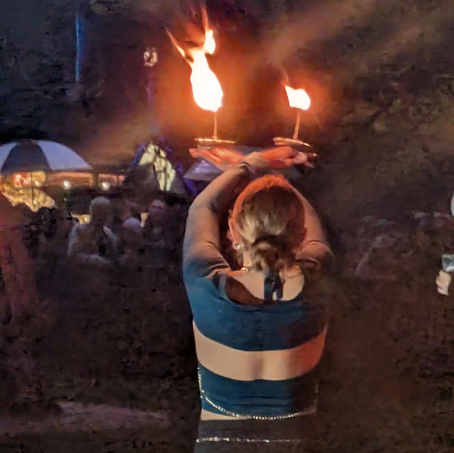 Solstice at CERES 2026, back of a fire dancer